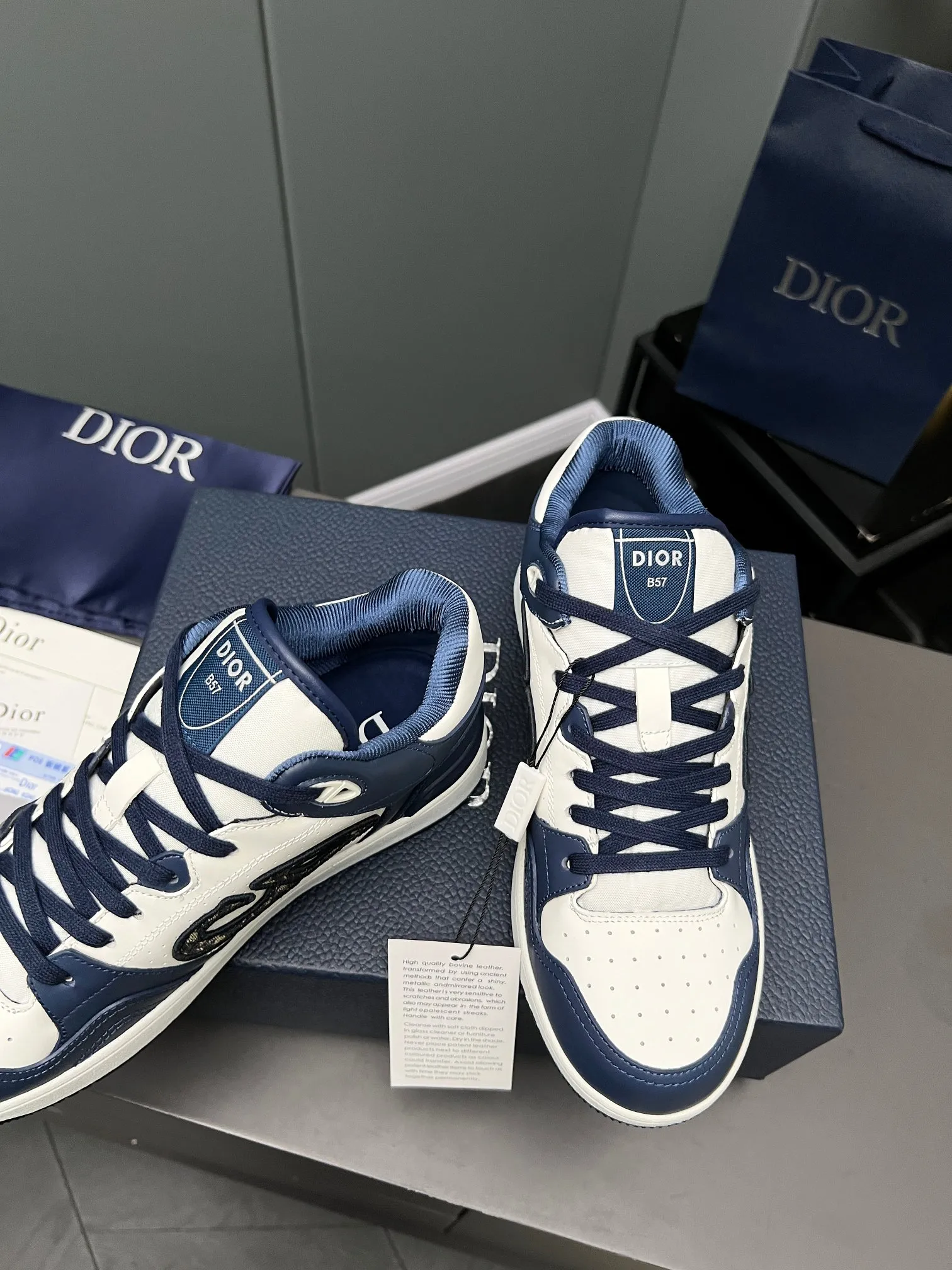 Men's Men's Shoes 💰600 Dior DiorB57 top version of low-top sneakers! ! ! Navy blue with beige smooth first-layer cowhide, fully oiled edges, T men's shoes 💰U outsole.  The 2024 autumn men's wear series has made a wonderful debut, a new classic item launched by Dior. Crafted from smooth first-grain cow leather in navy blue and beige, it's accented by a large leather heat-stamped CD logo on the sides. The distinctive laces of the same color match the color of the shoe body, and the opening and closing are decorated with various classic details on the tongue, sole and back side to enhance the style. The eyelet details, upper stitching and heel strip panels of the same color highlight the dynamic charm of its sports style. Exclusive two-color molded T men's shoes 💰U outsole is light, comfortable, non-slip and wear-resistant, the mesh lining and feet are customized with original colors, soft and breathable. Exquisite production technology highlights the grade, and can be matched with all kinds of clothing to create a refined look.